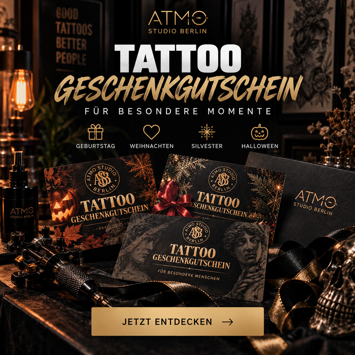 Promotional graphic for an ATM0 Studio Berlin 'Tattoo Geschenkgutschein' gift card set. The image shows three black gift cards with gold and white branding, one wrapped in a red ribbon, arranged on a dark table with a tattoo machine, skull, and warm ambient lighting.
